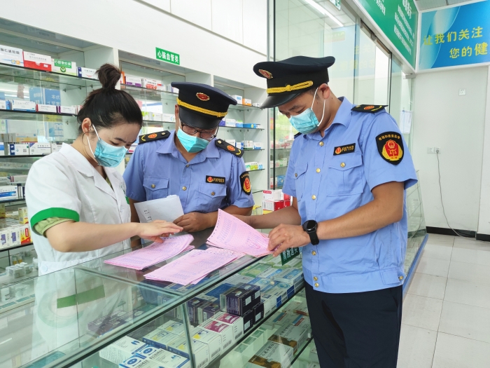 圖為監(jiān)管人員在一家藥店檢查。