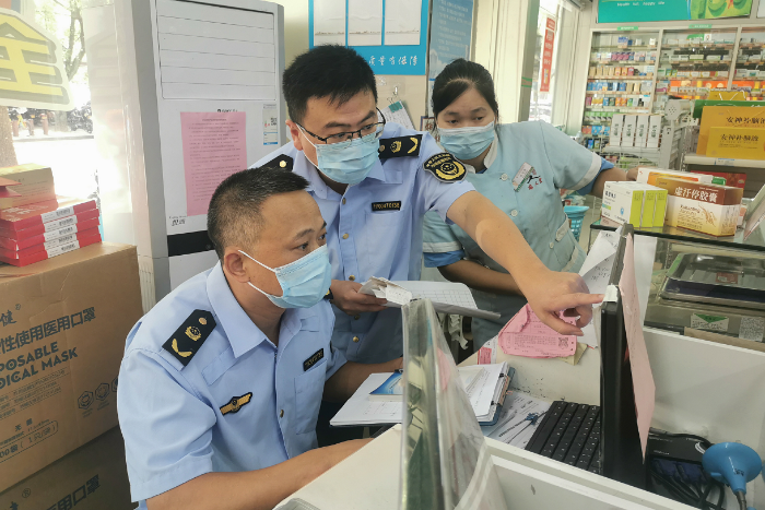 圖為該局執(zhí)法人員在景區(qū)一家藥店檢查“四類藥品”購藥信息登記。