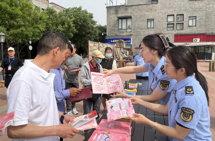 圖為該局監(jiān)管人員向社區(qū)居民發(fā)放化妝品科普手冊(cè)。